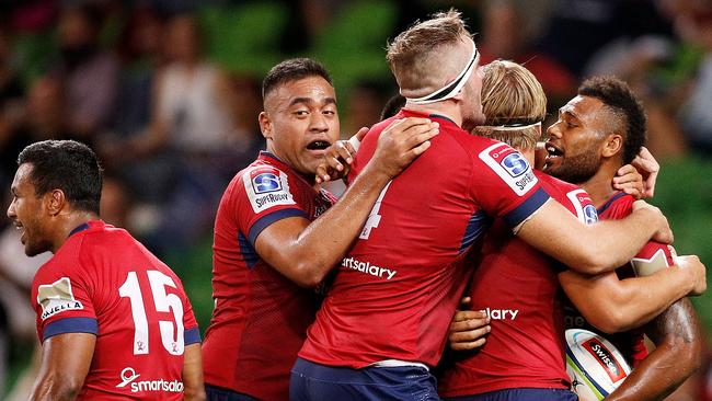 The Reds celebrate a try to Samu Kerevi (right).