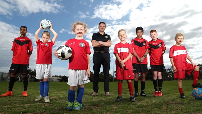Team 11 investor Tony Selak and youth players. Picture: Hamish Blair