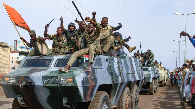 People cheer members of Sudan's armed forces in a military parade in Gadaref on August. Picture: AFP