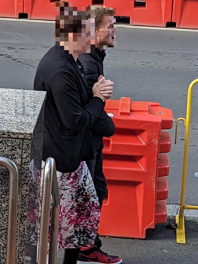 Joshua Corin Vaughan, 27, (back) walks with a woman from court. He is charged with negligent driving causing death after allegedly striking a male pedestrian on Main St, Huonville on November 28, 2022.