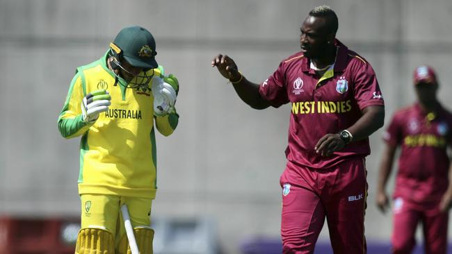 Russell checks on Khawaja after he was hit on the helmet.