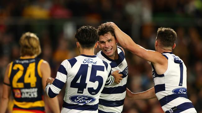 ADELAIDE, AUSTRALIA - MARCH 22: Tom Hawkins of the Cats celebrates a goal with Brad Close and Shaun Mannagh during the 2024 AFL Round 2 match between the Adelaide Crows and the Geelong Cats at Adelaide Oval on March 22, 2024 in Adelaide, Australia. (Photo by Sarah Reed/AFL Photos via Getty Images)