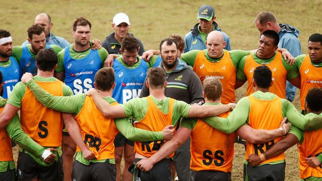 Wallabies coach Michael Cheika speaks to his players during training at Weigall Sports Ground.