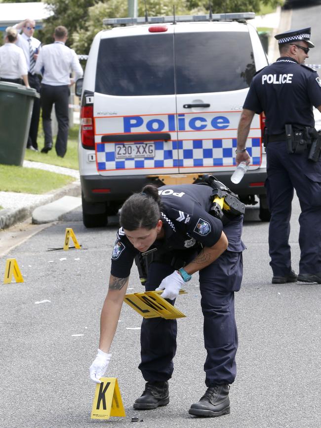 Police investigators work the crime scene. Picture: Steve Pohlner