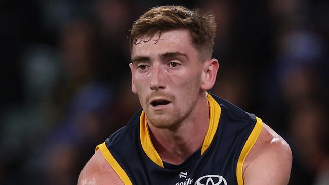 ADELAIDE, AUSTRALIA – JUNE 06: Mark Keane of the Crows handpasses the ball during the 2024 AFL Round 13 match between the Adelaide Crows and the Richmond Tigers at Adelaide Oval on June 06, 2024 in Adelaide, Australia. (Photo by James Elsby/AFL Photos via Getty Images)