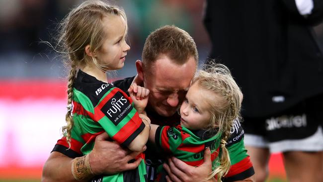 Jason Clark hugs his daughters Milla and Andi after the Rabbitohs’ nail-biting victory over the Dragons. Picture: Getty Images