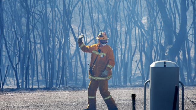 An out of control bushfire jumps Wine Country Drive and smashed head on into the village of North Rothbury, north of Cessnock. Picture: Peter Lorimer.