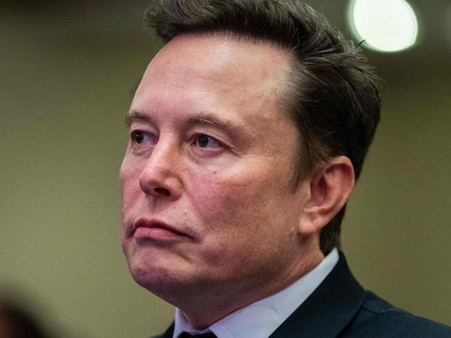 TOPSHOT - Elon Musk listens as US President-elect Donald Trump speaks during a meeting with House Republicans at the Hyatt Regency hotel in Washington, DC on November 13, 2024. (Photo by Allison ROBBERT / POOL / AFP)