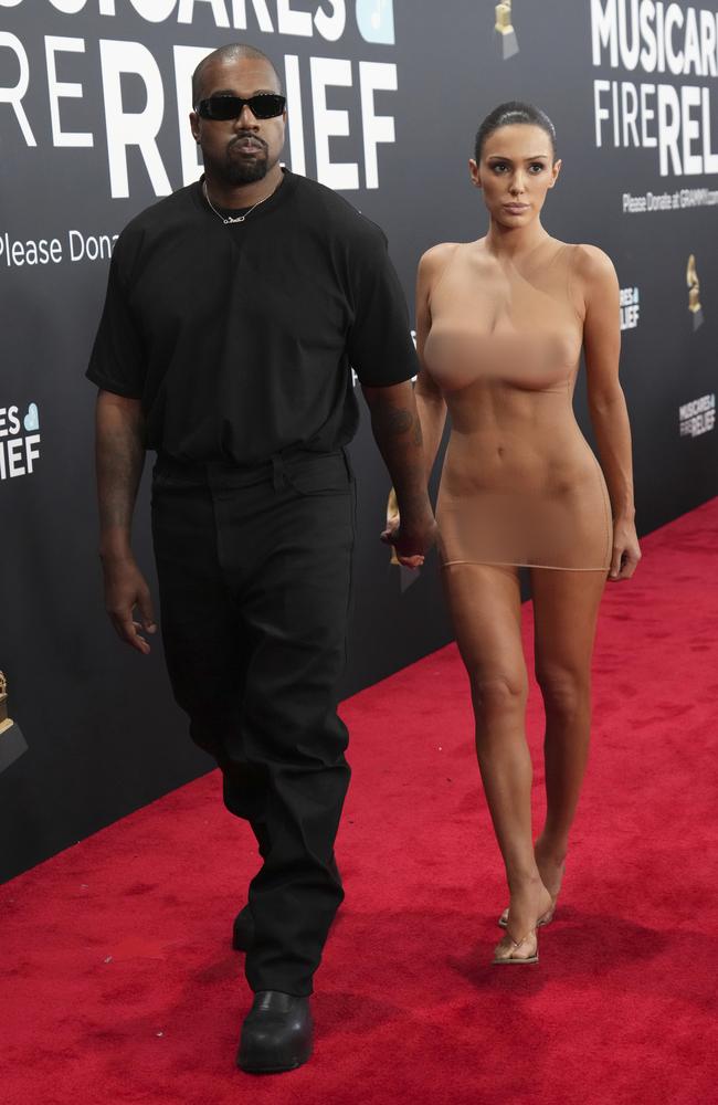 Kanye West arrives at the Grammys with wife Bianca Censori, who was wearing a sheer mini dress that exposed her body. Picture: AP