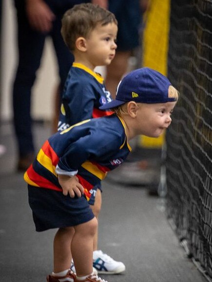 Hugo Walker and Sonny Sloane watch their dads in the changerooms after an Adelaide win. Picture: Adelaide Football Club