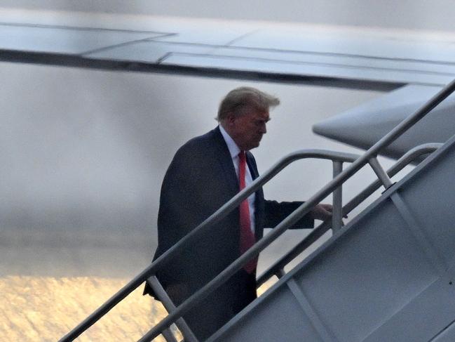 The former president boards his plane as he departs Atlanta airport after he was booked and photographed. Picture: Andrew Caballero-Reynolds/AFP