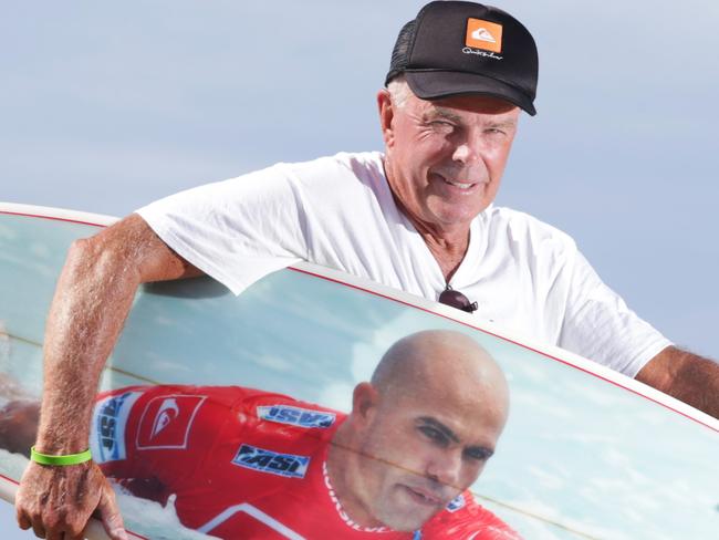 Gary Hill, 67, from Newcastle with his surfboard that has a picture of his surfing hero Kelly Slater on it. Gary is hoping for a signature from Kelly during the Quiksilver Pro. Pics Tim Marsden