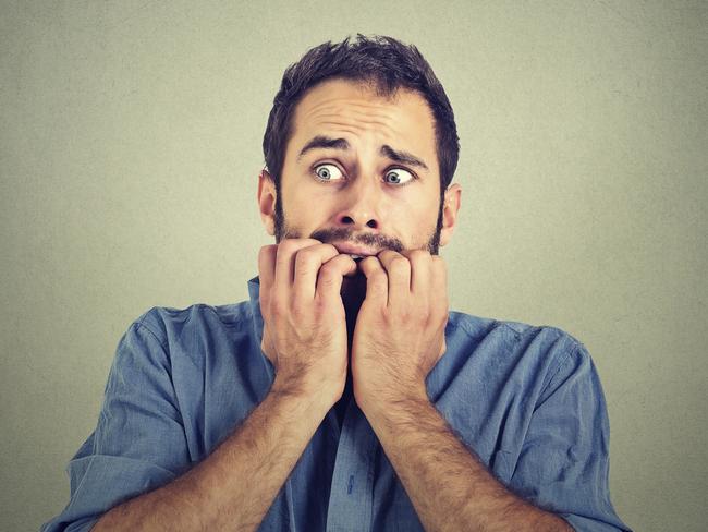 Portrait anxious young man biting his nails fingers freaking out, frightened, generic, scared