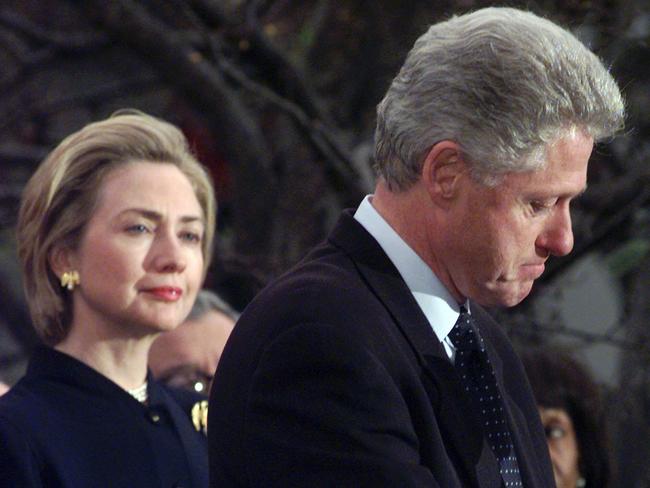 First lady Hillary Clinton watches President Bill Clinton pause as he thanks those Democratic members of the House of Representatives who voted against impeachment on December 19, 1998.