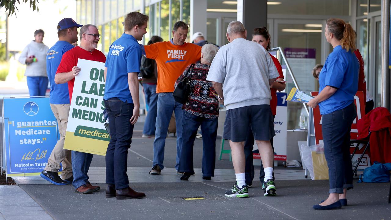 Voting early doesn’t mean escaping political party volunteers and how-to-vote cards. Picture: Chris Higgins