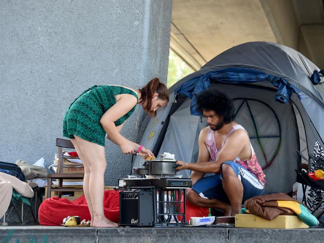 Selina, 22, and Mark cook lunch on their camping stove set up with their tent at Enterprize Park. Picture: Nicole Garmston