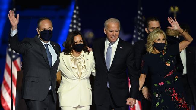 US President-elect Joe Biden and Vice President-elect Kamala Harris stand with spouses Jill Biden and Doug Emhoff.