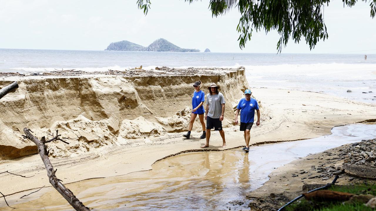 Ellis Beach Surf Lifesaving Club members Erin Buckley, Hugo Doessel and Mick Roberts walk along the beach after flood waters caused huge erosion. Picture: Brendan Radke