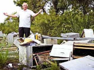 Haydon Burford, of First Sun Employment, was stunned when he arrived at Evans Head to find these beehives destroyed by vandals on trail bikes. Picture: Jay Cronan