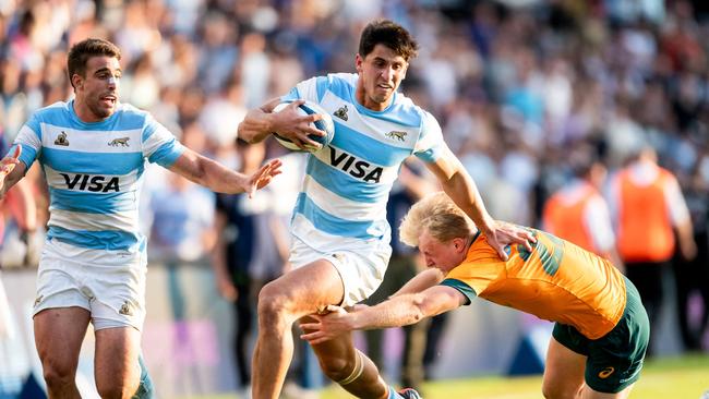 Los Pumas centre Lucio Cinti (C) breaks through the tackle of Wallabies fly half Tom Lynagh as Argentina posted a record score against Australia Picture: AFP