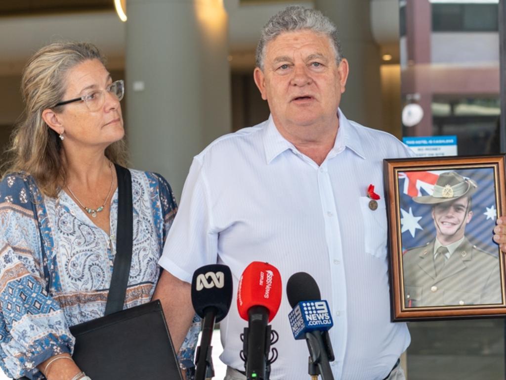 Robyn and John Halloran with a picture of their son Tom after speaking at the commission in Darwin. Picture: Supplied