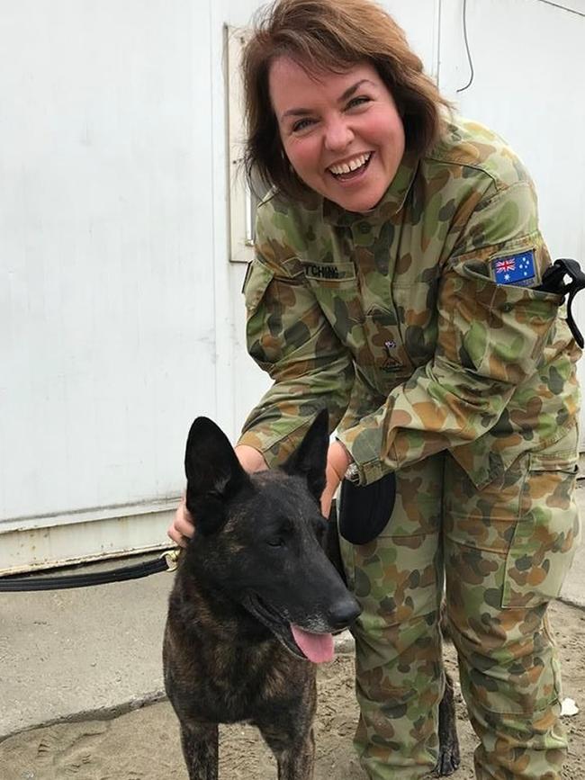 Senator Kimberley Kitching was passionate about Australia’s national security and is picture here with Attila the dog while visiting Defence personnel in Afghanistan. Picture: Supplied