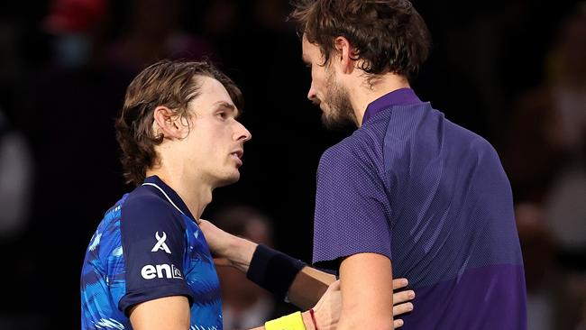 Alex De Minaur is congratulated by Daniil Medvedev. Photo by Julian Finney/Getty Images.