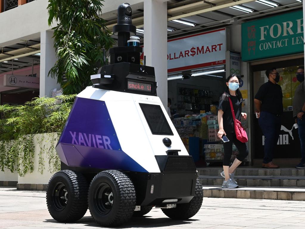 An autonomous robot named ‘Xavier’ patrols a shopping and residential district in Singapore to blast warnings at people engaging in bad behaviour. Picture: Roslan Rahman/AFP