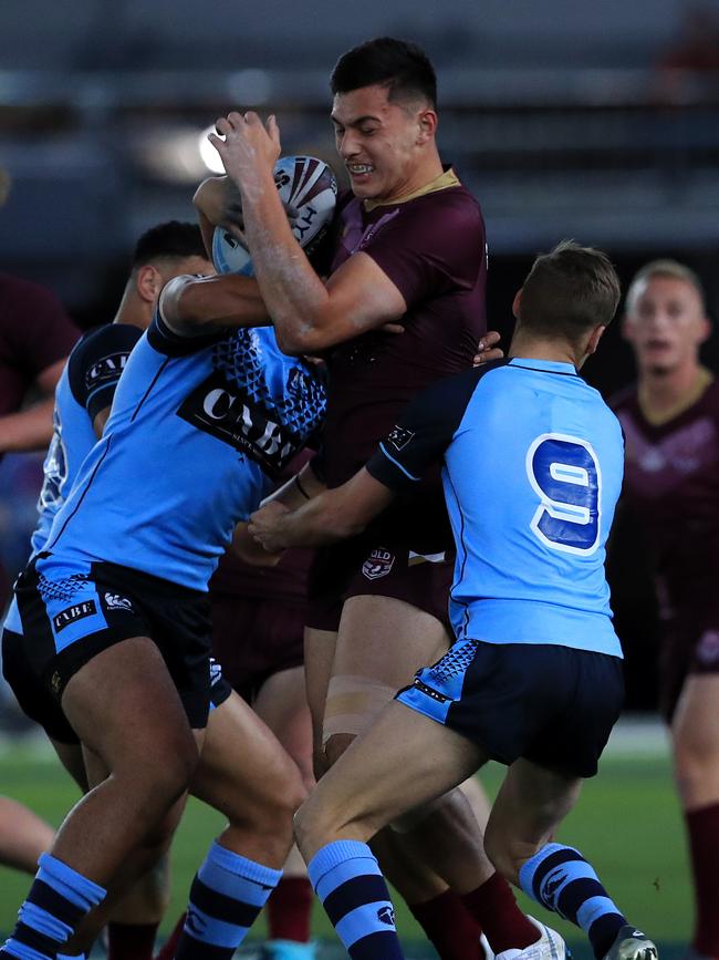 Fa’asuamaleaui towers over his Blues opponents during an U18 game last year. Picture: Adam Head