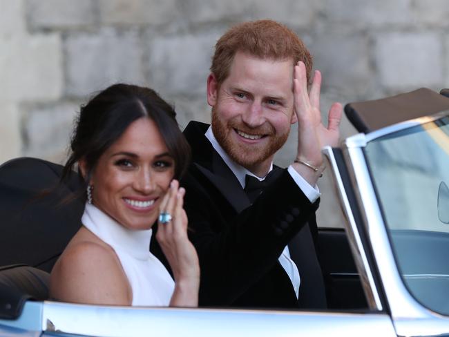 The new Duke and Duchess of Sussex give a royal wave as they head to the wedding reception. Picture: AFP/Steve Parsons. Picture: AFP/Steve Parsons