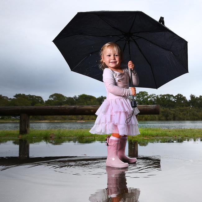 Eden Herlihy, 2, from Currumbin makes the most of the wet weather. Picture: Adam Head