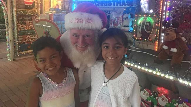 BRIGHT DISPLAY: Pat Kennedy at his Riverside Avenue home with visitors Aurora and Caitlyn O'Donoghue. Picture: Javier Encalada