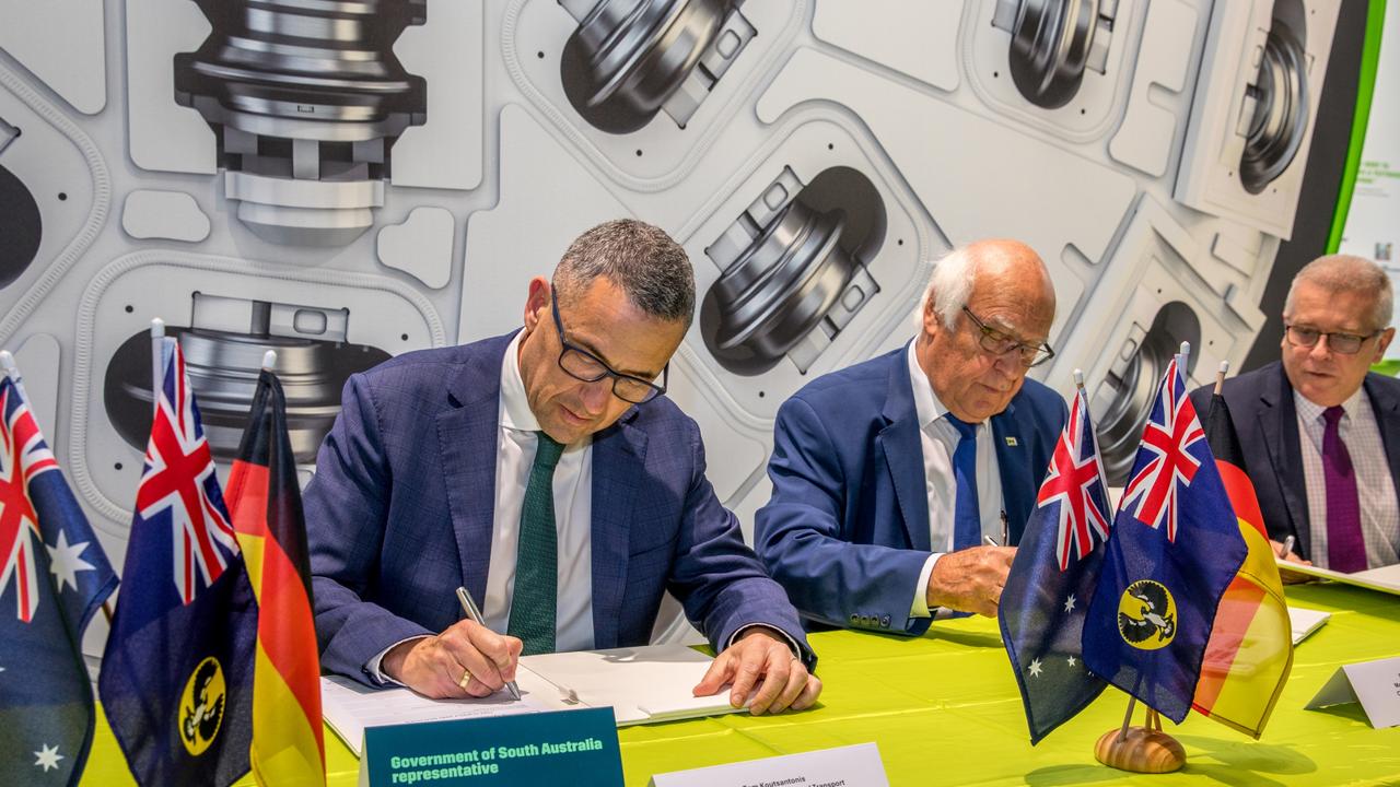 Infrastructure and Transport Minister Tom Koutsantonis and Martin Herrenknecht, founder of the company contracted to provide the tunnel boring machines, sign the contract in Germany. Picture: Supplied