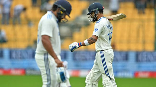 Indian captain Rohit Sharma (left) departs and Virat Kohli (right) went on to join him in the pavilion shortly after with the home side bowled out for 46 against New Zealand. Picture: Idrees Mohammed / AFP