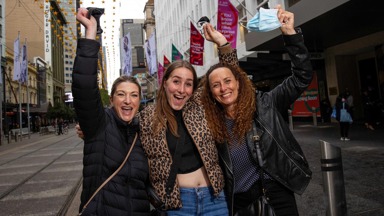 Annie Breene, Lucy Schaefer and Adrienne Schaefer ditching their masks outdoors on Bourke Street Mall. Picture: Mark Stewart