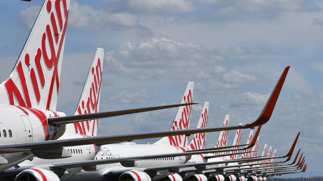 Grounded Virgin Australia aircraft are seen parked at Brisbane Airport.