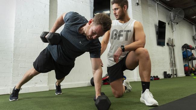 Randle works with client Josh Pinn. Picture: Simon Baker