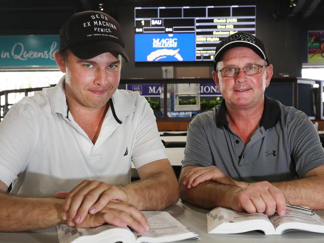 Trent Edmonds and Toby Edmonds check the sales guide at the Magic Millions complex at Bundall. Picture Glenn Hampson