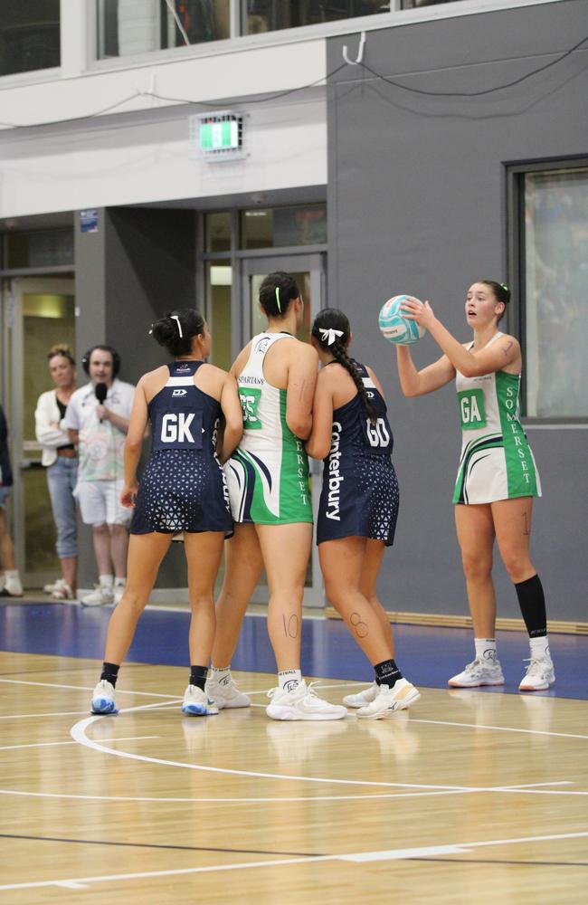 QISSN 2024 division one grand final - Canterbury College v Somerset College. Pictured: GA Marley Burns passing the ball in, GK Meletoa Pohiva defending GS Roxy Rhind