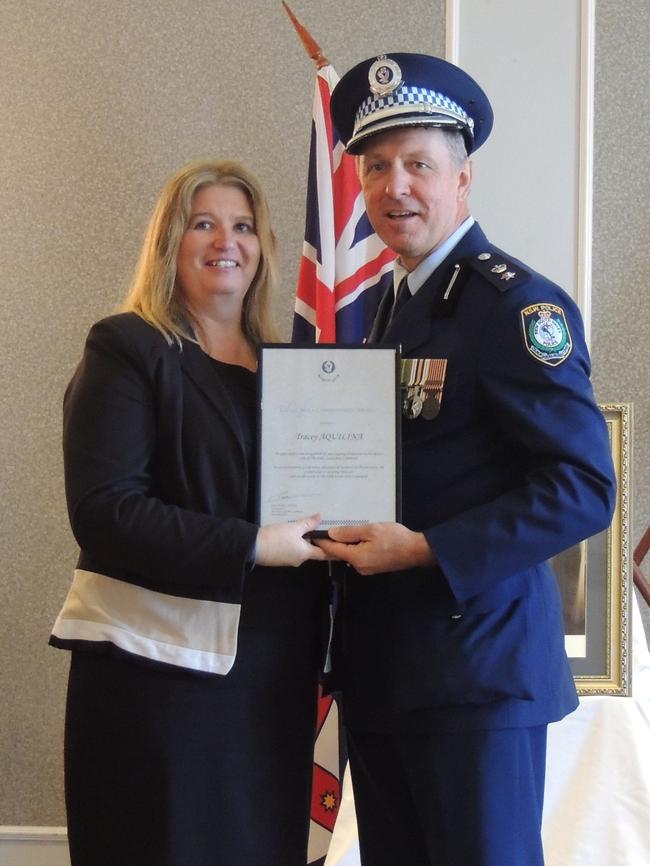 Tracey Aquilina receives her NSW Police Medallian 20 year lapel pin from Acting Commander Hills LAC Acting superintendent Jim Szabo