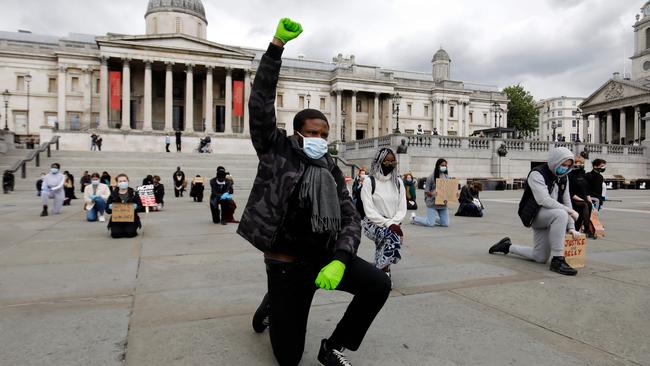 Protesters take a knee during a Black Lives Matter protest in London’s Trafalgar Square. Picture: AFP