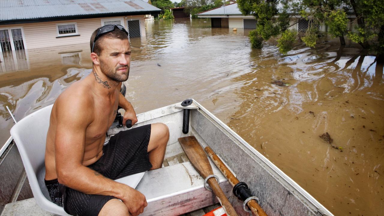 Barry Adams of Woodend used this dingy to help his family move possesions and themselves to higher ground on Leslie Street at East Ipswich. Photo: David Nielsen / Queensland Times