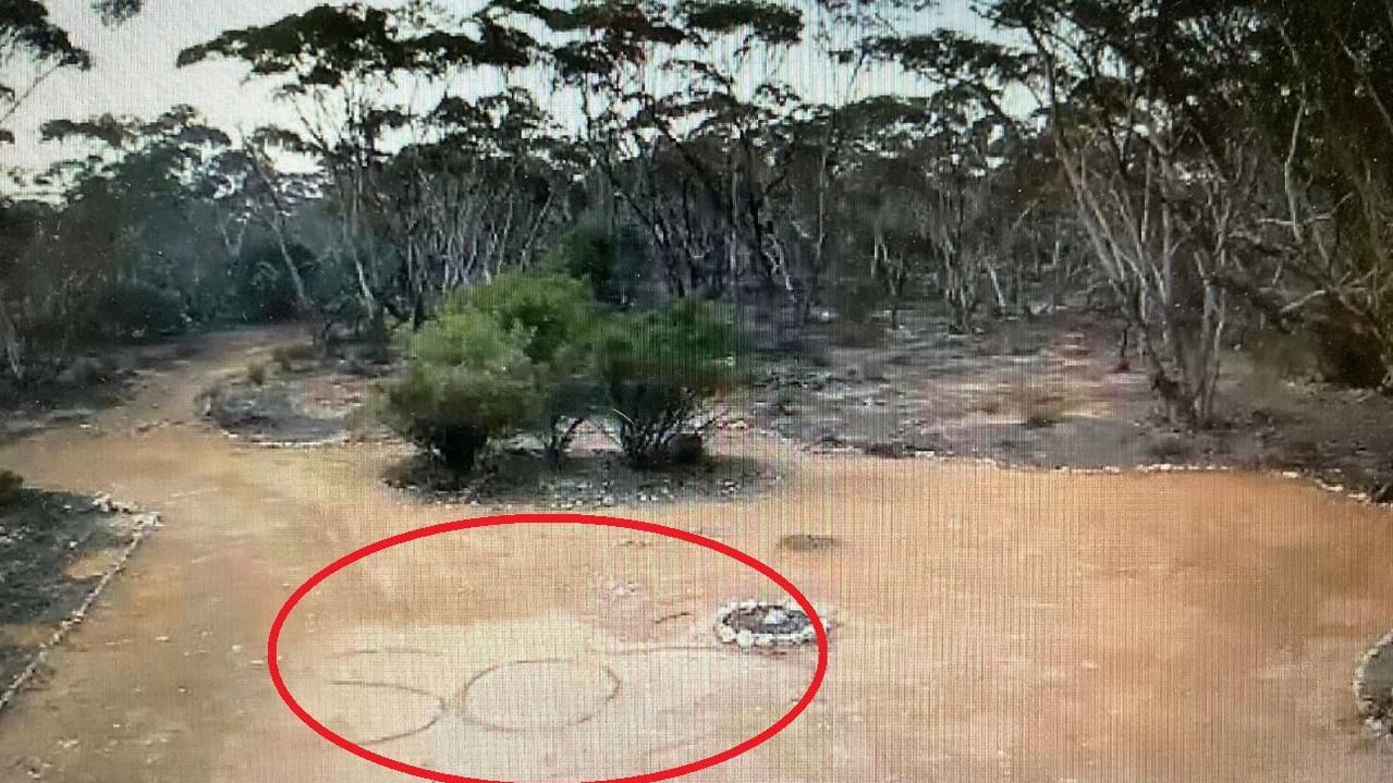 The SOS message scrawled in the dirt was spotted on a CCTV camera. Picture: Channel 9