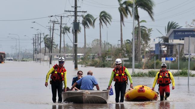 Ten year anniversary of Cyclone Yasi. Severe Cyclone Yasi 2011. Aftermath. Ingham Floods. Members of the Swift Water Response team carry out an emergency evacuation in Townsville Road. Picture: Evan Morgan