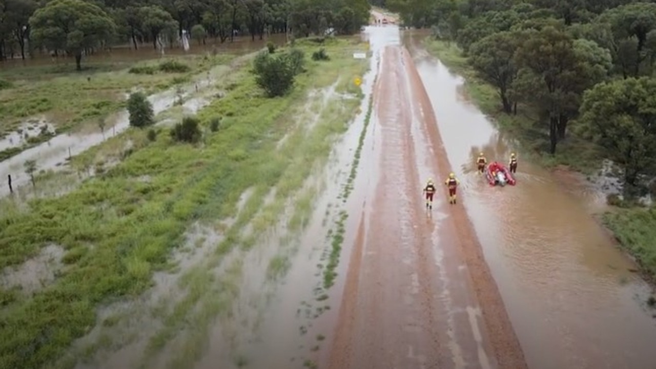 Swift water rescue crews rescued a driver stranded on his ute's roof after his vehicle was swept of the roadway at Balyendo crossing. Image: QFD