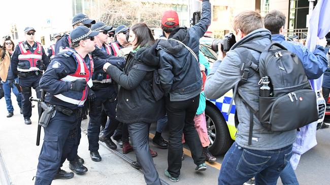 Protesters face a wall of police in front of a Melbourne court on Monday ahead of the appearance of the leader of a far-right group accused of offending Muslims during a rally against a mosque. Picture: AAP Image/James Ross