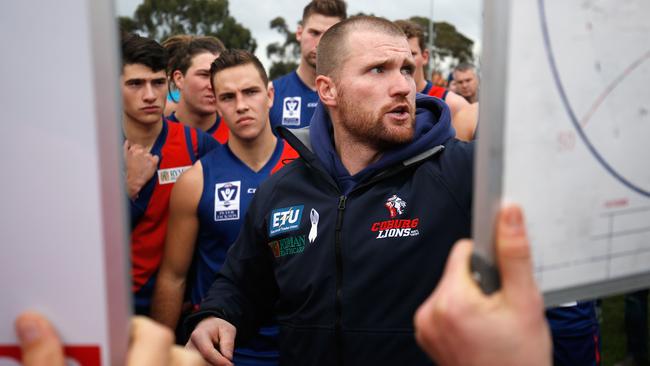 Coburg coach Leigh Adams talks to his players.