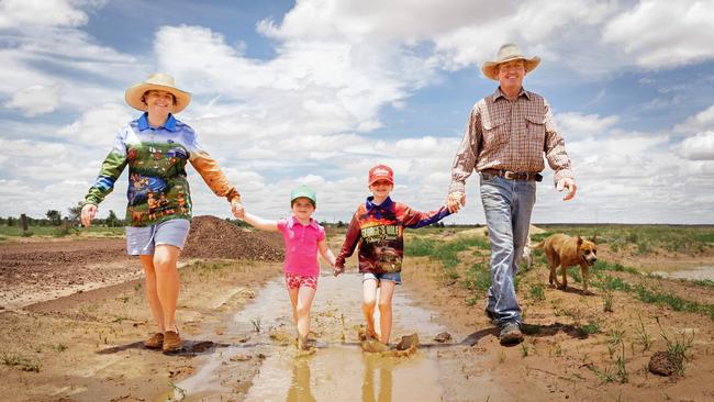 Relieved Queensland farmers Teneille and Rodney Ham from Mac Downs, 20km east of Barcaldine, with Sophie, 7, Jayden, 5, and cattle dog Roxy. Picture: Aaron Skinn