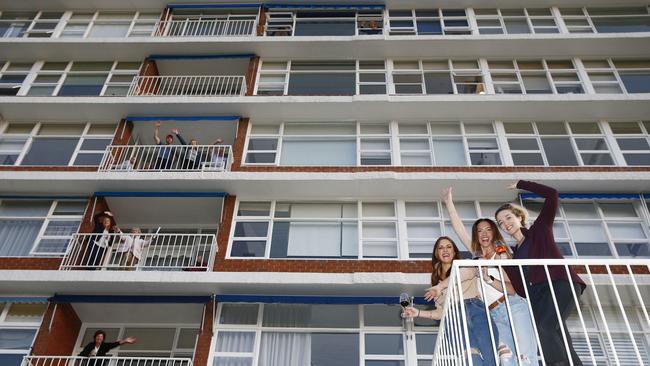 L to R: Rebecca McGrath, Ruth Melody and Kerrie O'Callaghan join other residents singing form the balconies. Picture: John Appleyard