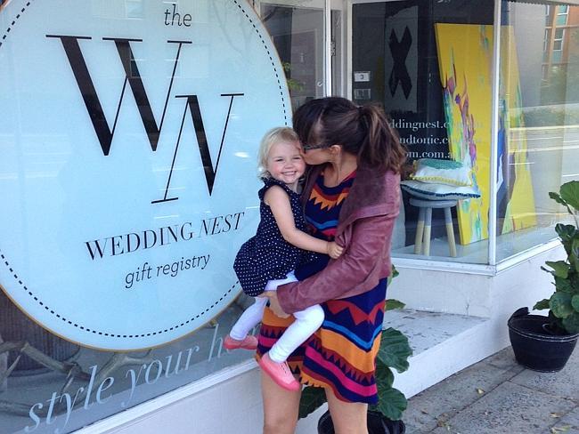 Jacqui Scruby with daughter Sienna in front of her store in Mosman.